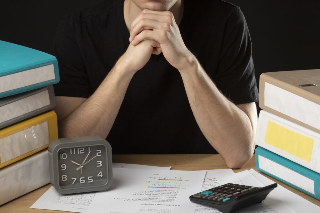 Business owner looking stressed while reviewing late BAS deadlines and tax documents.